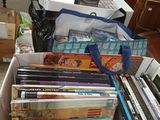 a box full of books sitting on the floor next to a desk
