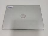 the back of a laptop computer sitting on top of a white table