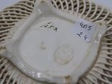 a white plate with a cat on it on top of a wicker basket