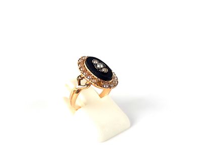 une image représentant une bague en or sertie d'une pierre noire entourée de diamants
