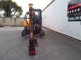 a picture of a construction vehicle parked in front of a building