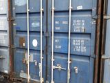 a blue shipping container sitting on the side of the road