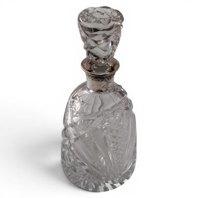 an image of a clear glass bottle with a silver stopper
