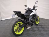 a picture of a white and black motorcycle parked in a garage