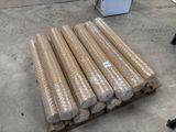many rolls of cardboard sitting on a pallet in a warehouse
