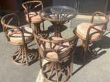 four chairs and a table with a glass top on the street