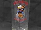 a glass that has a picture of a man holding a beer