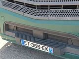 a close up of the front bumper of a green truck