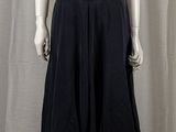 a mannequin wearing a white top and black skirt