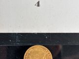a close up of a gold coin in a box on a table