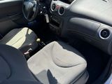 the interior of a car with the door open showing the driver ' s seat and dashboard