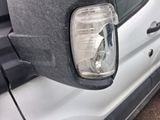 a close up of a car ' s headlight and side mirror