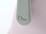 a close up of a pink purse with the word dior on it