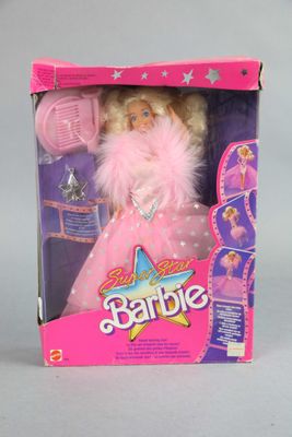 doll in a box with a pink dress and pink hair