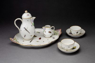 un service à thé comprenant une théière, des tasses et des soucoupes