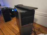 a computer tower with a keyboard and mouse on the floor