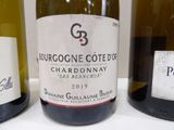 three bottles of wine are lined up on a table