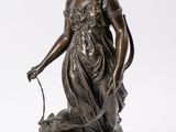 an antique bronze statue of a woman with a dog on a marble base