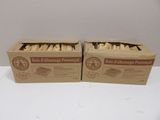two boxes of food sitting on top of a table next to each other