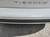 a close up of a car ' s rear end with a badge on it