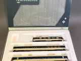 three blue and white train cars are in a box on a table