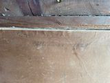 a close up of a piece of wood with writing on it