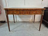 a small wooden table with two drawers on it