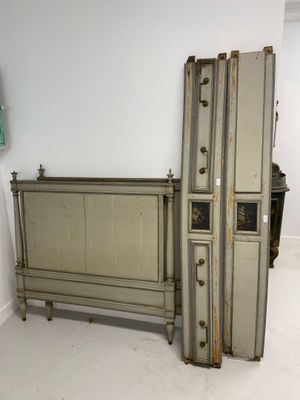 a bed that has a bunch of luggage on top of it