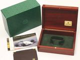 a wooden box with a watch inside of it