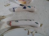 three pieces of porcelain on the table next to a plate