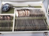 silverware in a white case with a spoon and spoon rest