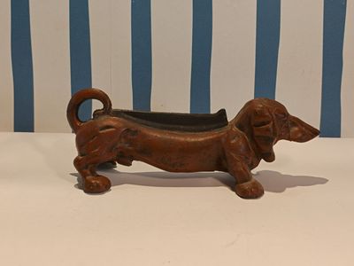 a small brown dog shaped planter on a table