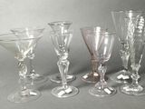 five wine glasses sitting next to each other on a table