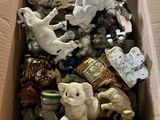 a cardboard box filled with assorted toys and figurines