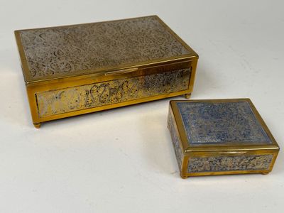 two boxes that are sitting on a white surface