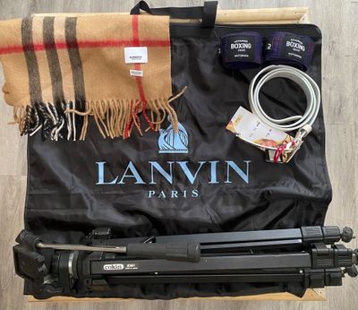 a camera and a tripod sitting on a wooden floor