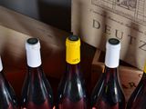 several bottles of wine are lined up in a wooden crate