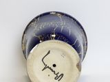 a blue and white vase with a writing on it