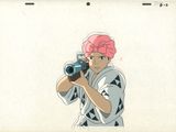 cellule d'animation représentant un homme portant un turban rose et tenant un appareil photo