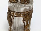 a glass jar with a lid that has a bird on it