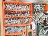many different types of screws and nuts in a box