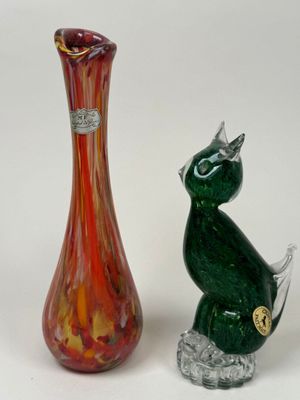 two vases sitting next to each other on a white surface