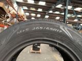 tires are lined up in a large warehouse with shelves and pallets