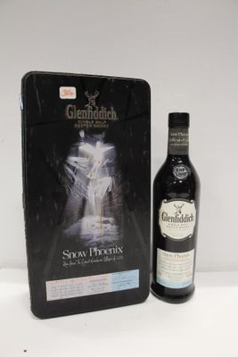 the bottle and box of glenfiddichh is next to the bottle of glenfiddichh