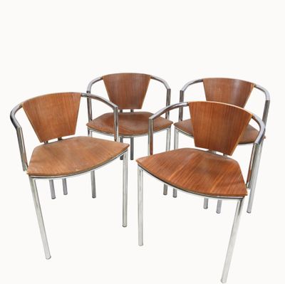 four wooden chairs with chrome steel legs and a wooden seat