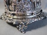 a silver plate with a picture of animals on it