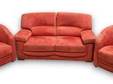 three red chairs and a couch in a room with a white background