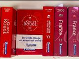 several red boxes of cigarettes are lined up on a shelf