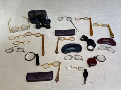 a lot of glasses, keys, and other items laid out on a table