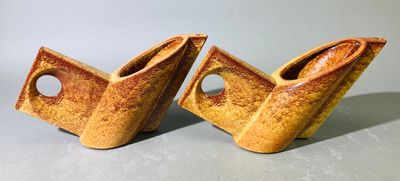deux vases bruns posés l'un à côté de l'autre sur une table